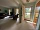 Inviting living room features neutral carpet, an open entrance, and bright natural light at 5938 Sharon Rd, Charlotte, NC 28210