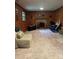 Cozy living room features wood paneling, a brick fireplace, and comfortable seating at 5938 Sharon Rd, Charlotte, NC 28210