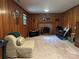 Wood-paneled living room with brick fireplace and a comfortable seating area at 5938 Sharon Rd, Charlotte, NC 28210