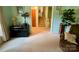 Bright living room with neutral carpet and light walls, open to a staircase and a dining area at 5938 Sharon Rd, Charlotte, NC 28210