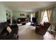 Spacious living room with multiple seating areas, plush carpet, and ample natural light at 5938 Sharon Rd, Charlotte, NC 28210