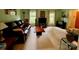 Large living room with neutral carpet, light walls, and big windows, creating a bright, open space at 5938 Sharon Rd, Charlotte, NC 28210