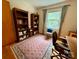 Home office setup with bookshelves, desk, and a chair, creating a productive workspace at 5938 Sharon Rd, Charlotte, NC 28210