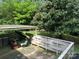 Cozy covered patio with a swing, perfect for relaxing and enjoying the outdoors at 5938 Sharon Rd, Charlotte, NC 28210