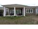 Relaxing back porch, complete with sliding doors and columns; perfect for outdoor lounging and entertaining in a backyard at 6642 Star Dr, Sherrills Ford, NC 28673