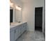 Bathroom with double vanity, mirrors, and access to the walk-in closet at 6642 Star Dr, Sherrills Ford, NC 28673