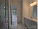 Modern bathroom with double vanity, glass shower, and views into the bedroom at 6642 Star Dr, Sherrills Ford, NC 28673