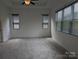 Carpeted bedroom featuring two bright windows and a modern ceiling fan at 6642 Star Dr, Sherrills Ford, NC 28673