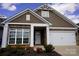 Inviting home featuring stone accents, a white garage door, and a well-manicured front yard, offering appealing curb appeal at 6642 Star Dr, Sherrills Ford, NC 28673
