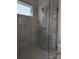 Contemporary tiled walk-in shower with a glass door and modern fixtures at 6642 Star Dr, Sherrills Ford, NC 28673