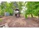 Large backyard featuring a custom-built playhouse and wood storage at 724 Lagan Ct, Fort Mill, SC 29715