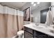 Classic bathroom with a toilet, a dark vanity, a framed mirror, and a warm-toned shower curtain at 724 Lagan Ct, Fort Mill, SC 29715