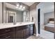 Bathroom with a white countertop, espresso vanity, and framed mirror reflecting an adjacent bedroom at 724 Lagan Ct, Fort Mill, SC 29715