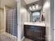 Well-lit bathroom with a dark vanity, white countertop, framed mirror, and patterned shower curtain at 724 Lagan Ct, Fort Mill, SC 29715