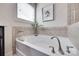 Close up of soaking tub with neutral tile surround in main bathroom at 724 Lagan Ct, Fort Mill, SC 29715