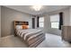 Well-lit bedroom featuring a wooden bed frame, plush carpeting, and a bright, airy feel at 724 Lagan Ct, Fort Mill, SC 29715
