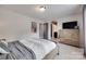Relaxing bedroom with wood furnishings, soft lighting, a cozy bed, and an ensuite bathroom at 724 Lagan Ct, Fort Mill, SC 29715