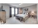 Comfortable bedroom featuring neutral tones, a wooden bed frame, and natural light from the windows at 724 Lagan Ct, Fort Mill, SC 29715