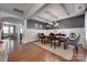 Elegant dining room with tray ceiling, modern chandelier, hardwood floors, and wainscoting at 724 Lagan Ct, Fort Mill, SC 29715