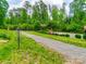 Disc golf course with gravel path, mature trees, and lush green space throughout the community at 724 Lagan Ct, Fort Mill, SC 29715