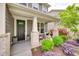 Inviting front porch with rocking chairs, stylish planters, and well-maintained landscaping at 724 Lagan Ct, Fort Mill, SC 29715