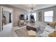 An elegant game room featuring modern lighting, plush ottoman, sofa, and fun arcade game at 724 Lagan Ct, Fort Mill, SC 29715