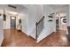 Inviting hallway with hardwood floors, staircase, and views to a living space at 724 Lagan Ct, Fort Mill, SC 29715