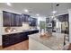 Modern kitchen with dark cabinets, granite countertops, stainless steel appliances, and a center island at 724 Lagan Ct, Fort Mill, SC 29715