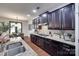 Kitchen featuring granite countertops, stainless steel appliances, dark cabinetry, and hardwood floors at 724 Lagan Ct, Fort Mill, SC 29715