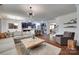Open-concept living space with a plush sofa, hardwood floors, and access to the kitchen and dining areas at 724 Lagan Ct, Fort Mill, SC 29715