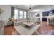 Spacious living room featuring a large sectional sofa, wood floors, and bright natural light at 724 Lagan Ct, Fort Mill, SC 29715