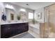 Main bathroom featuring double vanity, soaking tub, and walk-in shower at 724 Lagan Ct, Fort Mill, SC 29715
