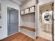 Mudroom with a built-in bench, storage cabinets, and hooks, and an adjacent powder room at 724 Lagan Ct, Fort Mill, SC 29715