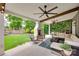 Expansive covered patio offers a cozy fireplace, comfortable seating, and lush backyard views at 724 Lagan Ct, Fort Mill, SC 29715