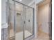 Walk-in shower with glass door and neutral tile surround in main bathroom at 724 Lagan Ct, Fort Mill, SC 29715