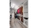 Spacious walk-in closet with custom shelving, drawers, hanging racks, and wood-look flooring at 724 Lagan Ct, Fort Mill, SC 29715