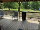 Inviting back deck with outdoor seating, offering a tranquil spot to enjoy the surrounding greenery and fresh air at 7494 Flat Creek Rd, Lancaster, SC 29720