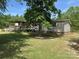 View of the home's back exterior featuring an inviting deck with a covered porch and well-maintained lawn at 7494 Flat Creek Rd, Lancaster, SC 29720
