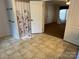 Bathroom featuring tile floors, a shower with a decorative curtain, and access to the bedroom at 7494 Flat Creek Rd, Lancaster, SC 29720