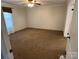 Cozy carpeted bedroom with a ceiling fan and a large window providing natural light at 7494 Flat Creek Rd, Lancaster, SC 29720