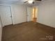 Spacious bedroom with ceiling fan, featuring two doors and neutral decor for a versatile living space at 7494 Flat Creek Rd, Lancaster, SC 29720