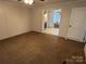 Bedroom featuring neutral carpet and access to a bathroom with a brick tub surround at 7494 Flat Creek Rd, Lancaster, SC 29720