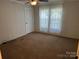 Cozy bedroom with neutral carpet and walls, offering a serene retreat for relaxation and rest at 7494 Flat Creek Rd, Lancaster, SC 29720