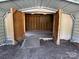 Open carport interior with wooden framing, offering a versatile space for storage or workshop projects at 7494 Flat Creek Rd, Lancaster, SC 29720