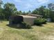 Spacious carport with a metal structure, providing covered parking and additional storage space for vehicles and equipment at 7494 Flat Creek Rd, Lancaster, SC 29720