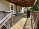 Cozy, covered porch area with wooden beams, a welcome wreath, and comfortable seating at 7494 Flat Creek Rd, Lancaster, SC 29720