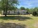 Charming ranch-style home with beige siding, red shutters, a ramp to the front door, and a spacious front yard at 7494 Flat Creek Rd, Lancaster, SC 29720