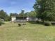 Ranch-style home with a ramp leading to a covered back deck and a spacious yard at 7494 Flat Creek Rd, Lancaster, SC 29720