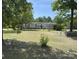 Ranch-style home with beige siding, red shutters, a front ramp, and a spacious front yard surrounded by trees at 7494 Flat Creek Rd, Lancaster, SC 29720