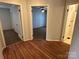Hallway featuring hard surface floors and doorways leading to bedrooms and bathrooms at 7494 Flat Creek Rd, Lancaster, SC 29720